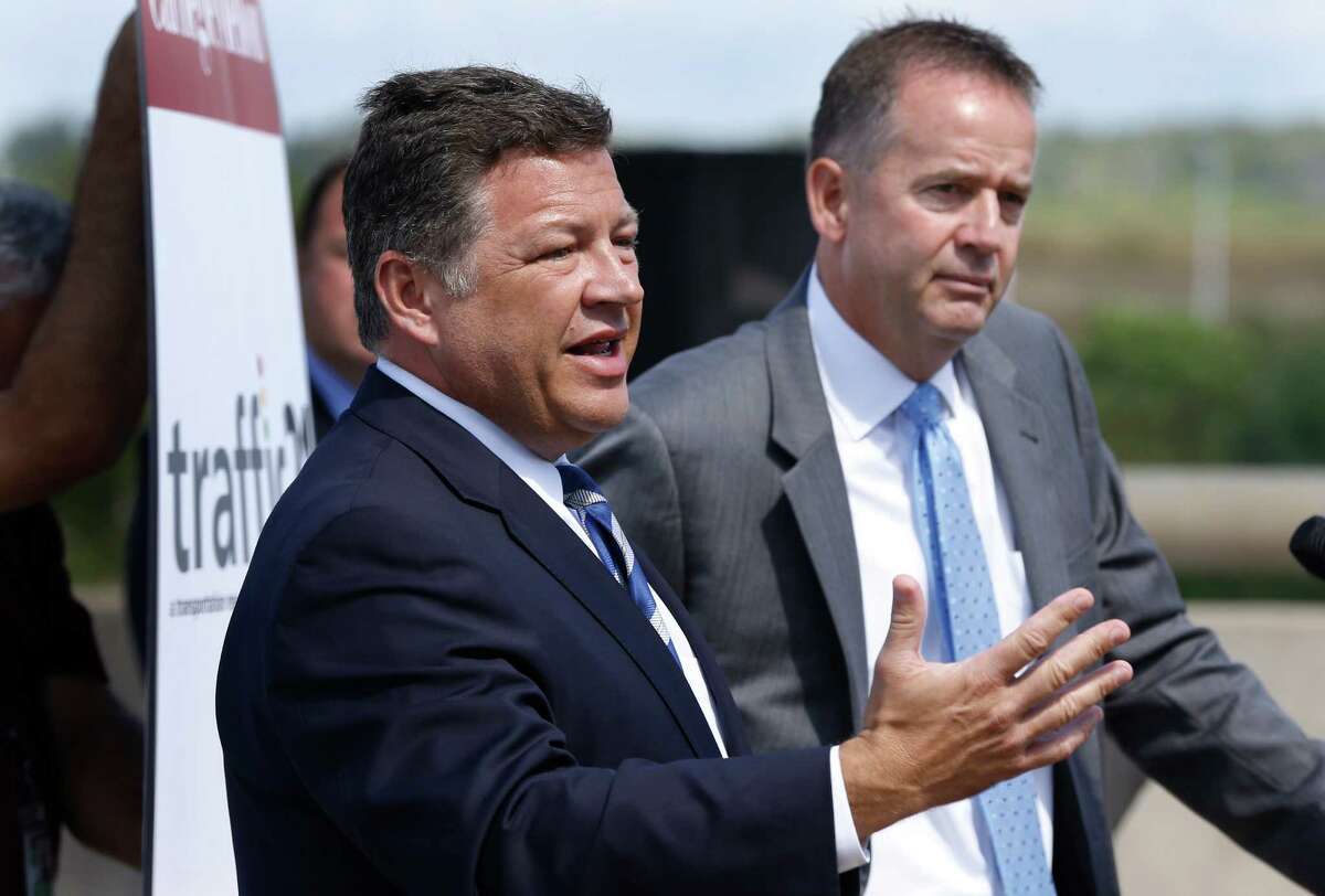 U.S. Rep. Bill Shuster, the chairman of the House Transportation and Infrastructure Committee, left, speaks at a news conference in Imperial, Pa. about the ride he and Barry Schoch, secretary of the Pennsylvania Department of Transportation, right, took to the Pittsburgh International Airport in Imperial, Pa. in a self-driven vehicle on Wednesday, Sept. 4, 2013. The Cadillac SRX that was modified by Carnegie Mellon University, was operated by a computer that used inputs from radars, laser rangefinders, and infrared cameras as it made the 33-mile trip from Cranberry, Pa., Butler County. A Carnegie Mellon engineer was in the driver's seat as a safety precaution. (AP Photo/Keith Srakocic)