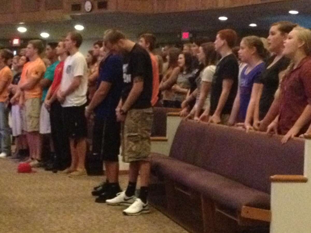 Worshippers pray for the school stabbing victims during a vigil at Spring Baptist Church on Wednesday evening.