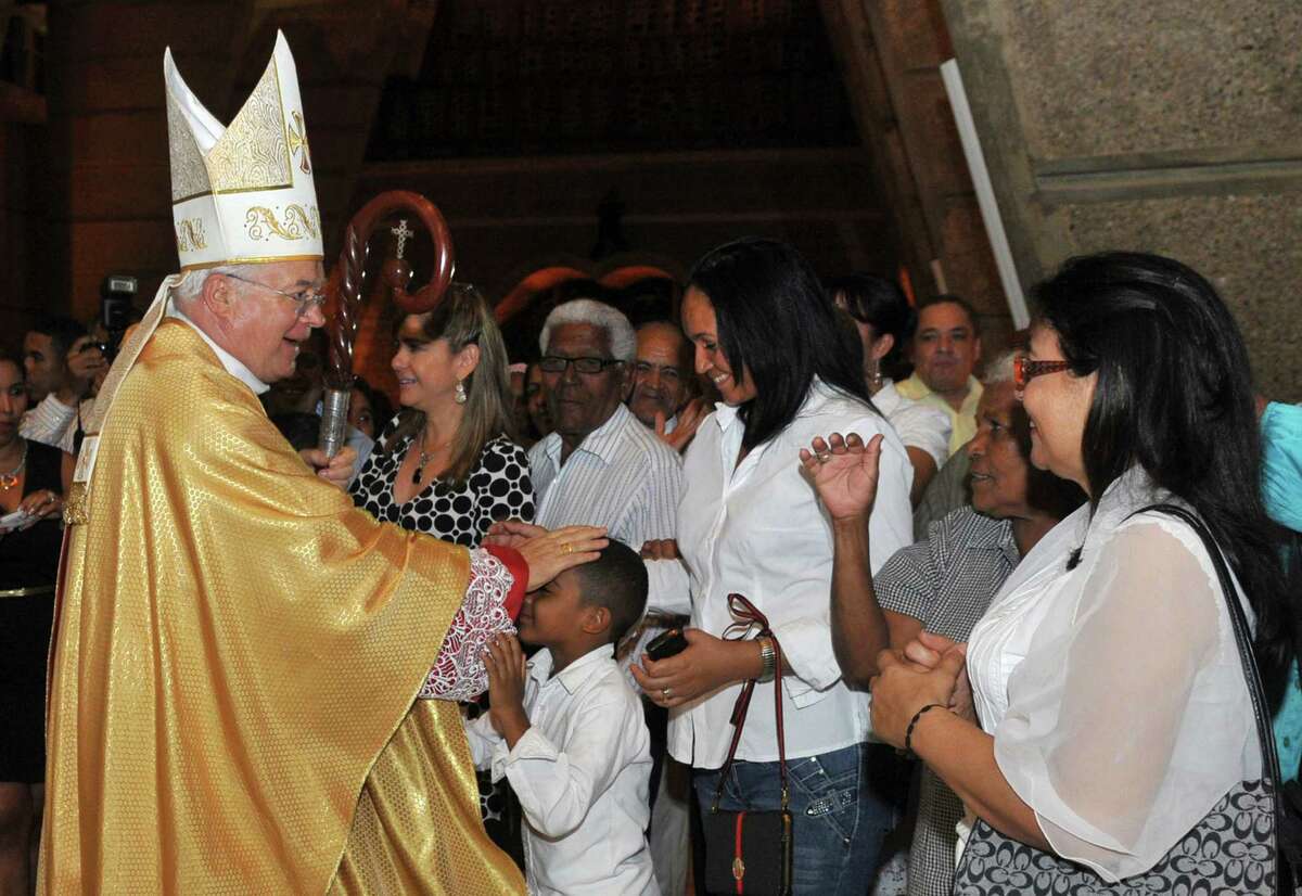 In this March 15, 2013 photo, Archbishop Josef Wesolowski, papal nuncio for the Dominican Republic, greets people after a Mass in Santo Domingo, Dominican Republic. Authorities in the Dominican Republic will look into allegations of child sex abuse against Wesolowski, following his abrupt removal from his post by the Vatican, Attorney General Francisco Dominguez Brito said Wednesday, Sept. 4, 2013, noting that his office is aware only of rumors. (AP Photo/Manuel Diaz)
