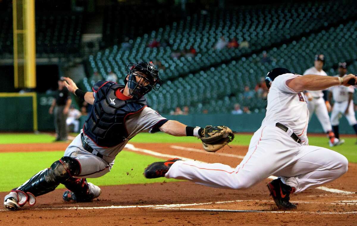 Brett Wallace eludes Twins catcher Chris Herrmann to score in the first inning Wednesday.