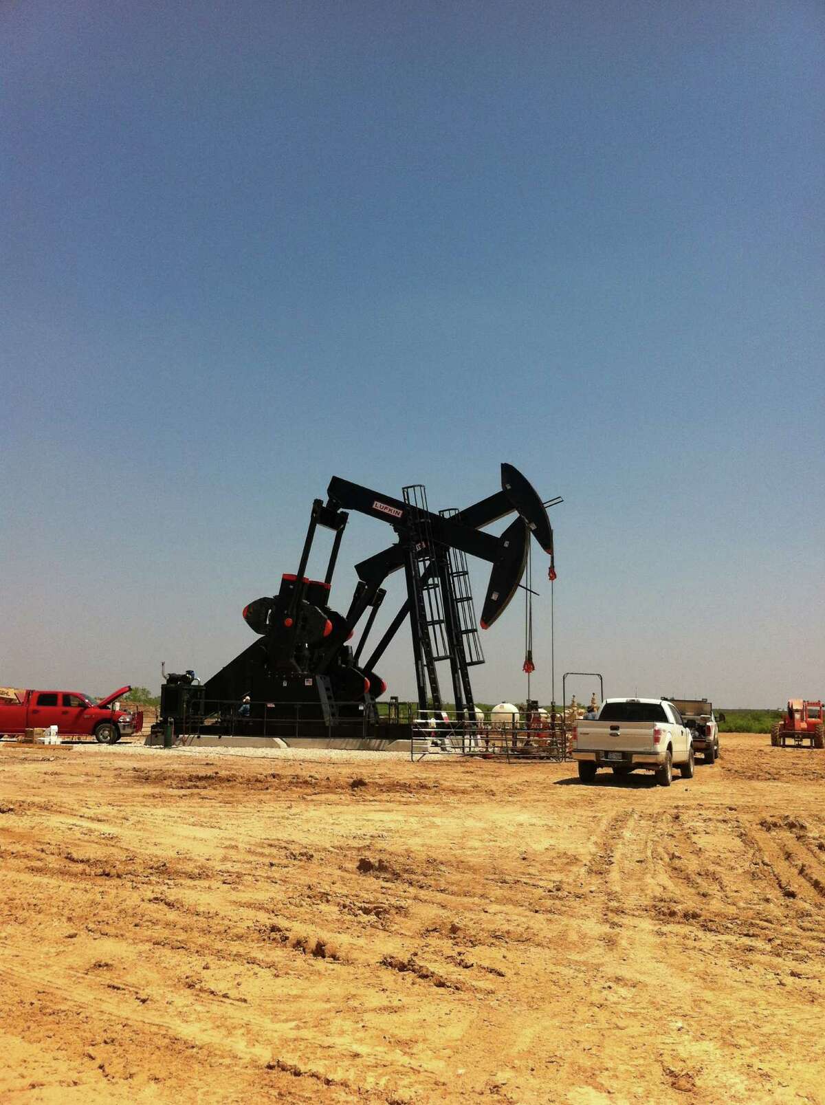 Pumping units draw from a well in Texas' Eagle Ford Shale, where a new government report predicts daily production will drop by almost 70,950 barrels next month.. (Carrizo Oil & Gas photo)