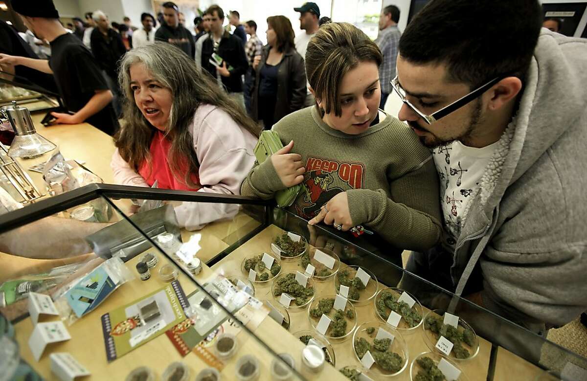 Laurita and Chris Campbell of Tracy, check out the variety of cannabis as Laurita's mom Rita Galvin, of Patterson does the same at the Harborside Health Center in Oakland, Calif. on Tuesday Apr. 20, 2010. The company is a distributor of medical marijuana.