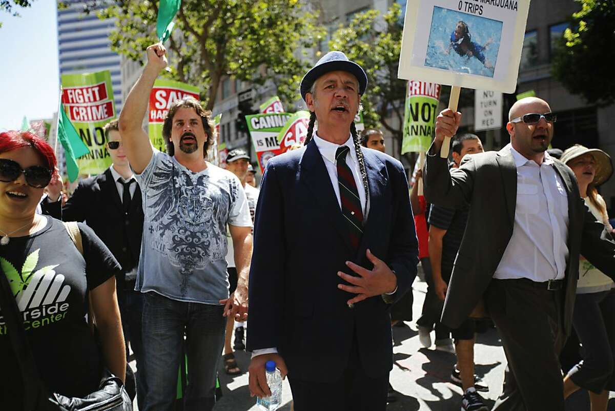 Steve De Angelo, Executive Director of Harborside Health Center, is walking in the front wile the protesters are marching down Broadway Street in Oakland, Calif. on Sunday, July 23, 2012.