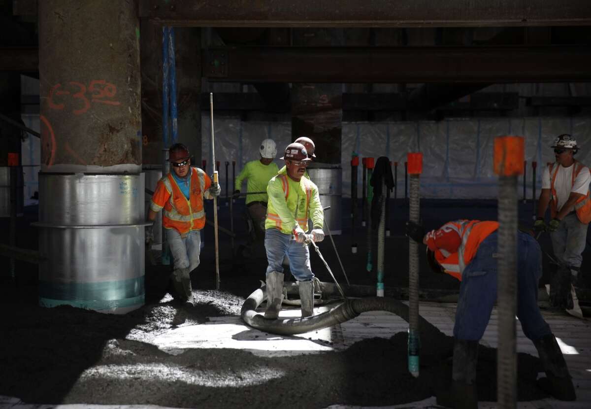 Workers work with oncrete being poured into a train box in Zone 2 for the future Transbay Transit Center's foundation on Thursday, September 5, 2013 in San Francisco, Calif.