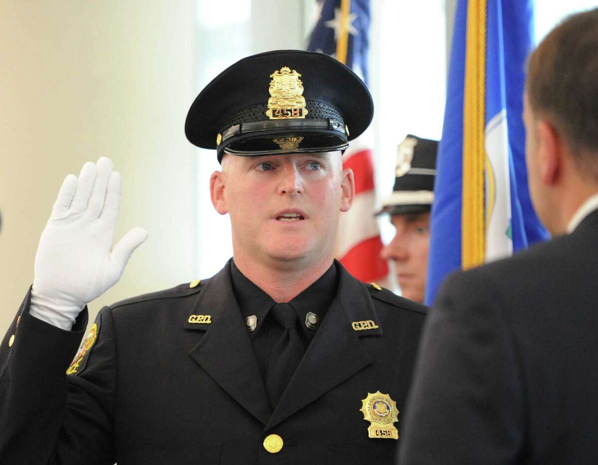 Greenwich Police Officer Ernest Mulhern is sworn in as a Sergeant by Greenwich First Selectman Peter Tesei during a promotion ceremony for Mulhern at Greenwich Police Headquarters, Thursday, Sept. 5, 2013.