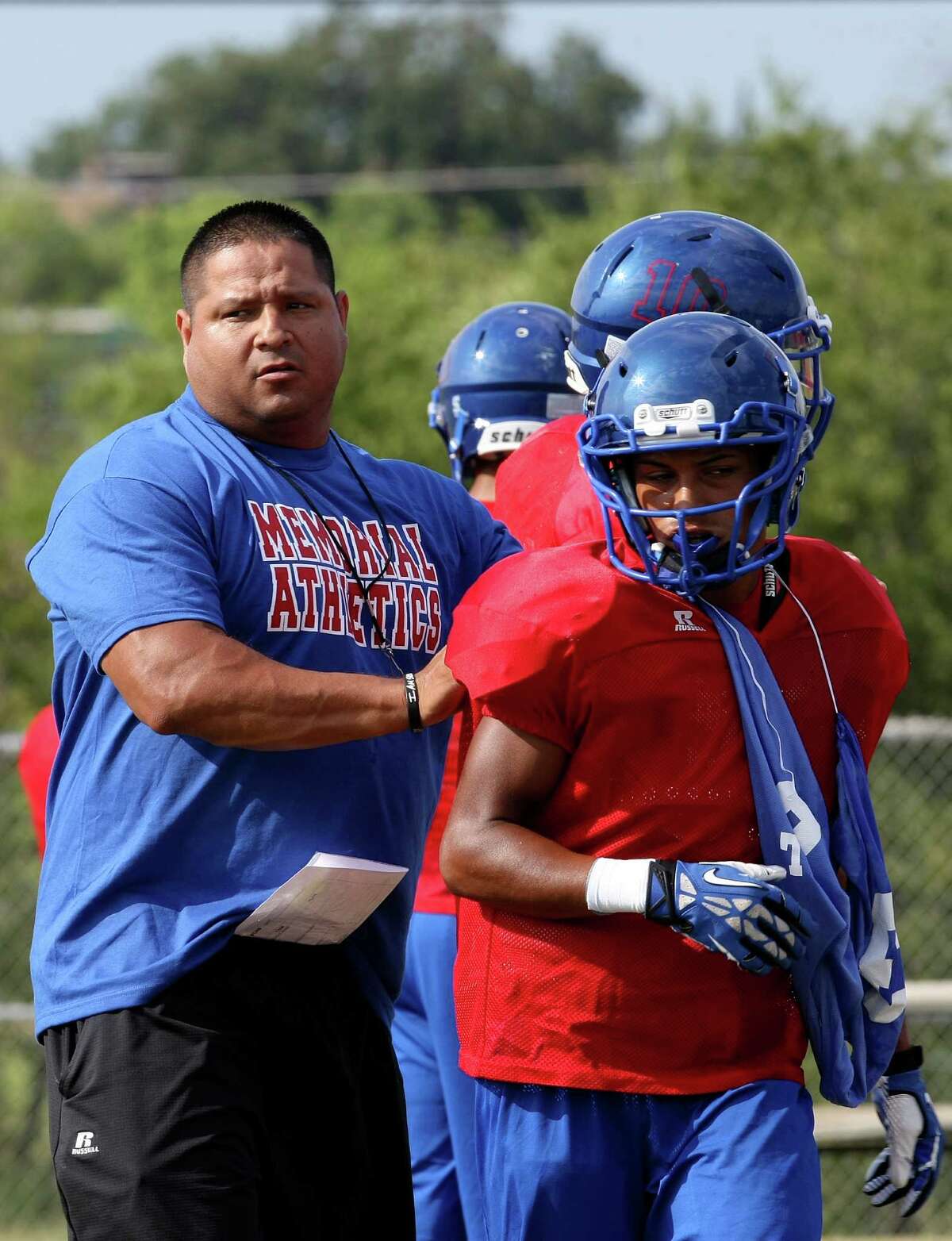 Memorial High School got its first on-field football victory since 2010 on Friday in a win against Pearsall. Head Coach Alex Guerra works with the team during practice on Thursday Sept. 5, 2013.