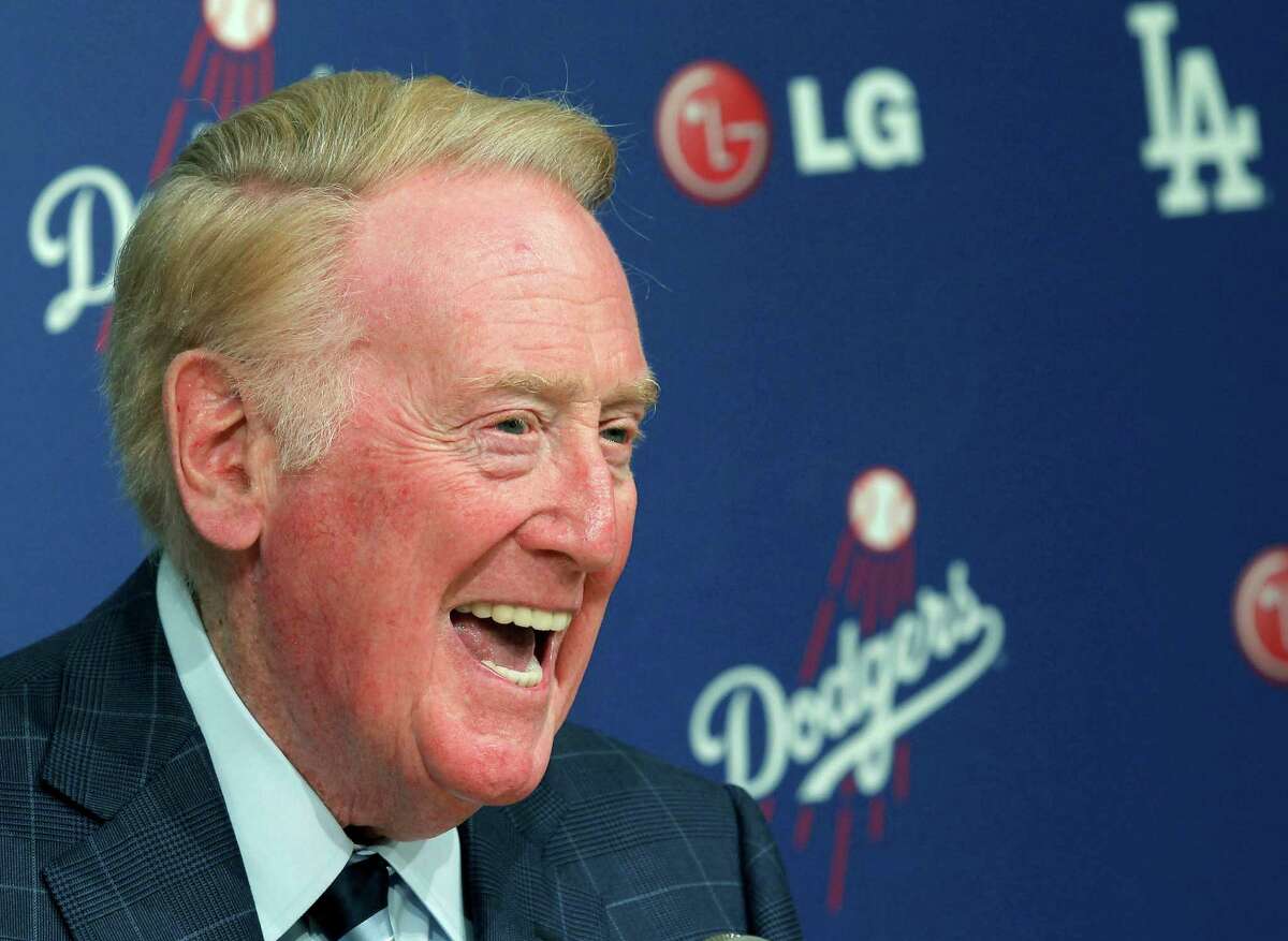 FILE - In this Aug. 23, 2013 file photo, Vin Scully, one of baseball's most beloved broadcasters, speaks during a news conference at Dodger Stadium in Los Angeles. Scully will serve as grand marshal of the 125th Rose Parade on New Year's Day in Pasadena, Jan. 1, 2014. (AP Photo/Nick Ut, File)