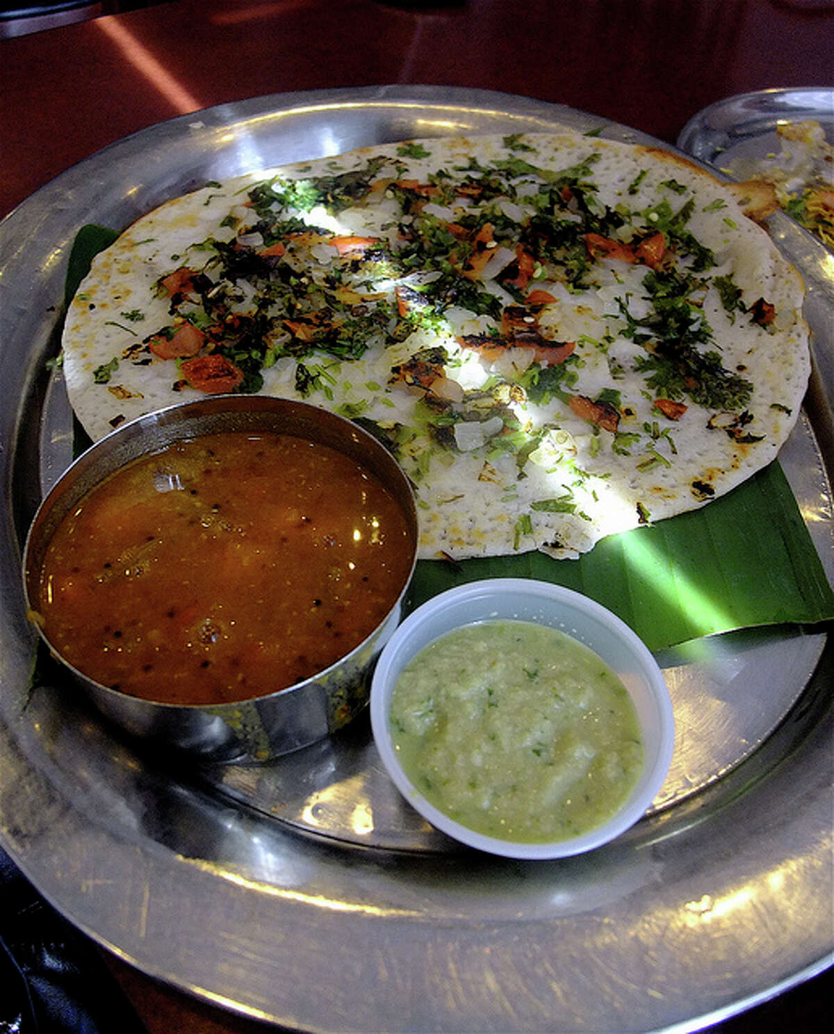 Spicy uttipam pancake with sambar and coconut chutney at Shri Balaji Bhavan.