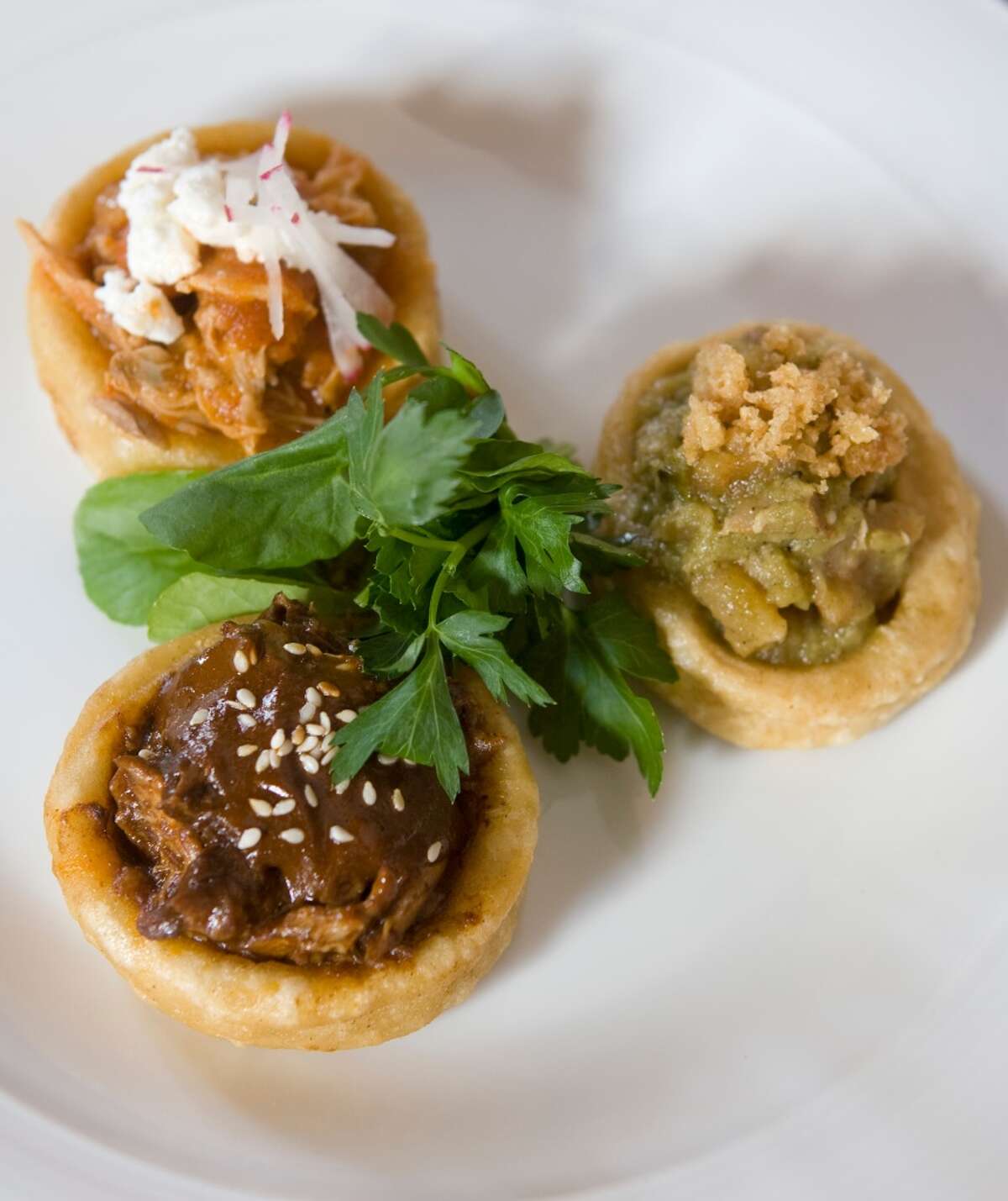 Duck mole sopesito, rabbit tinga and pork cracklings in salsa verde are a featured dish at Hugo's.