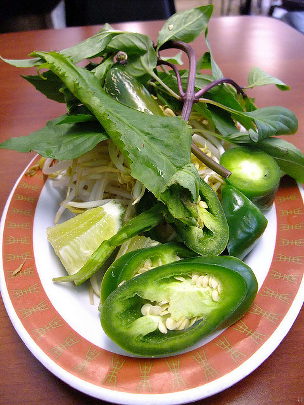Garnish plate with jalapeno, lime, Thai Basil, cilantro and bean sprouts at Pho Binh
