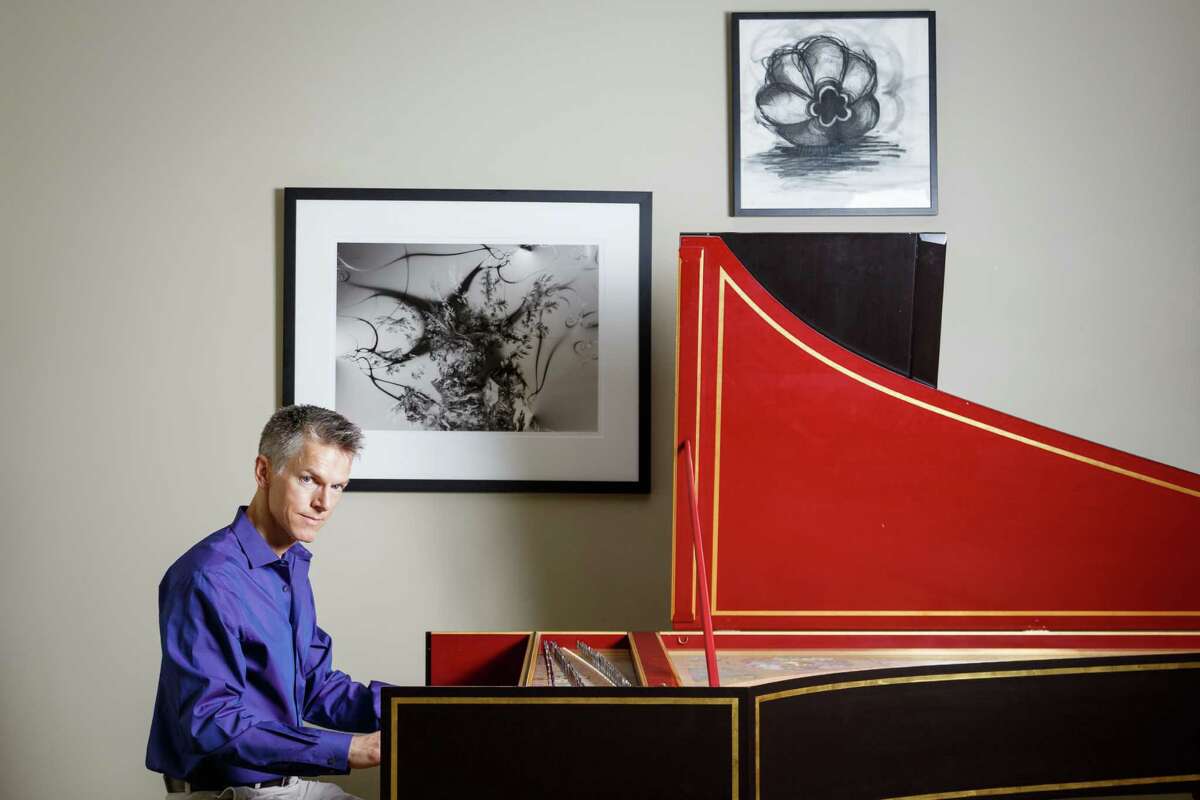 Matthew Dirst poses for a photo with his harpsichord at his home, Wednesday, Aug. 21, 2013, in Houston. Dirst is an organist, harpsichordist, University of Houston music professor and founder of the Ars Lyrica early music group. ( Michael Paulsen / Houston Chronicle )