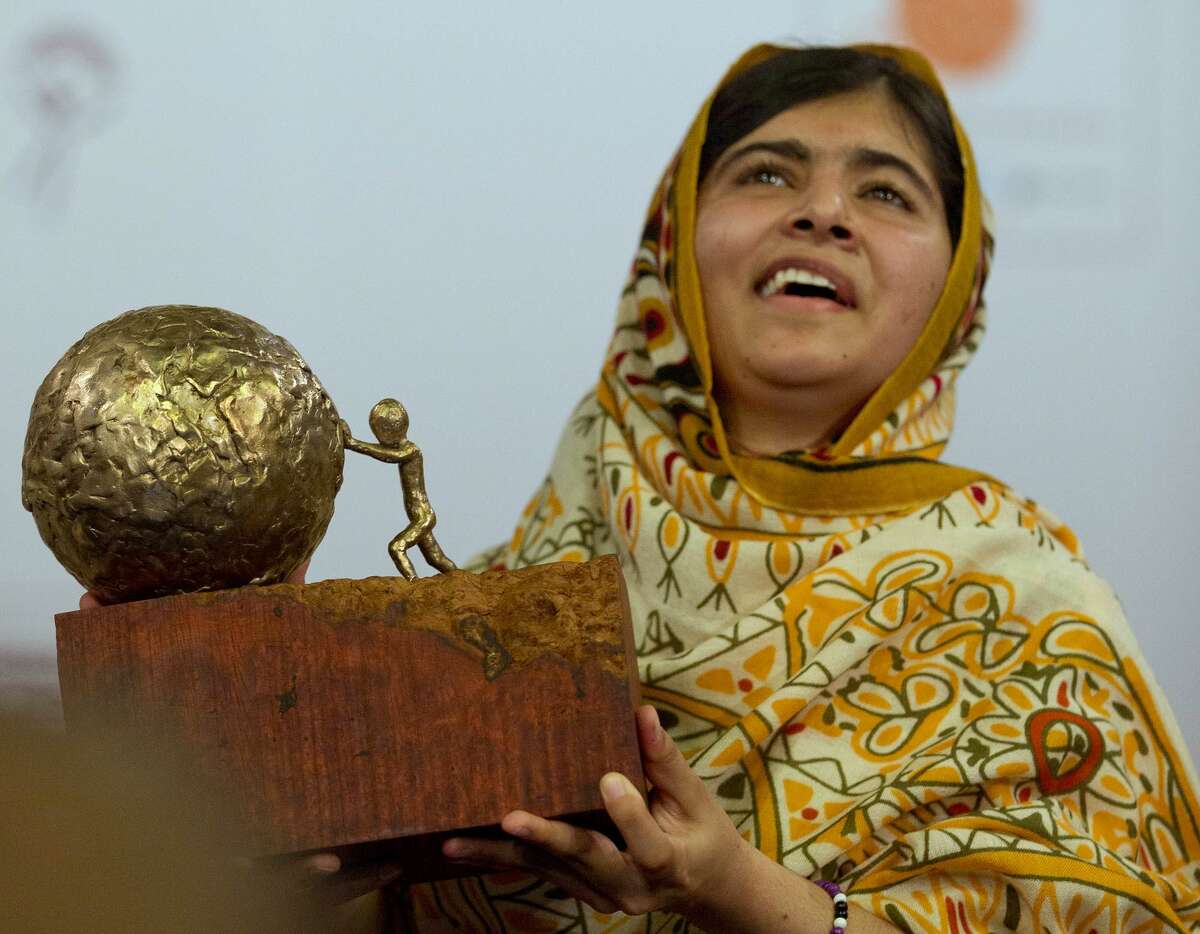 Pakistani teenager Malala Yousafzai, who was shot and injured by the Taliban for advocating girls' education, poses for photographers after being awarded the International Children's Peace Prize 2013 during a ceremony in the Hall of Knights in The Hague, Netherlands, Friday Sept. 6, 2013. (AP Photo/Peter Dejong)