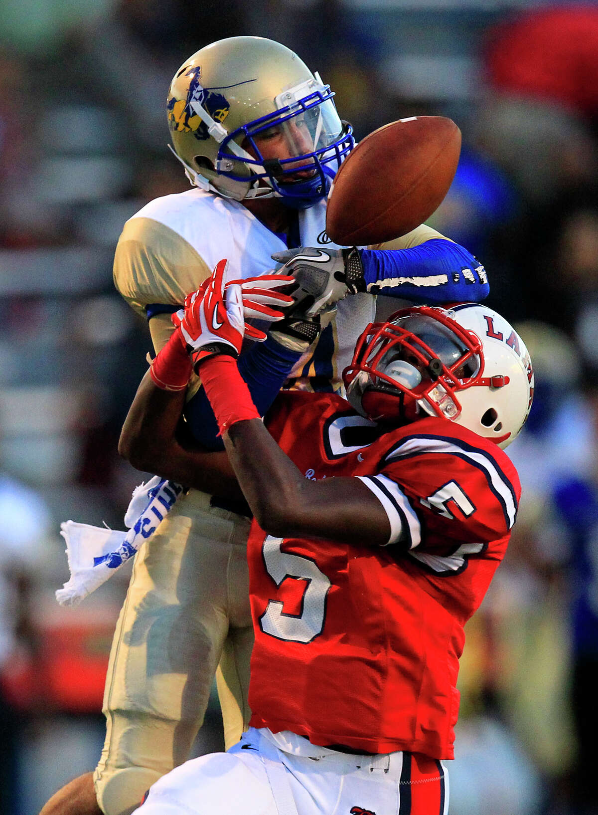 Despite Shahab Khorshidpanah's best efforts, Lamar's Holton Hill, right, breaks up the first-half pass to the Elkins receiver. The Redskins intercepted three passes en route to a 38-6 win.