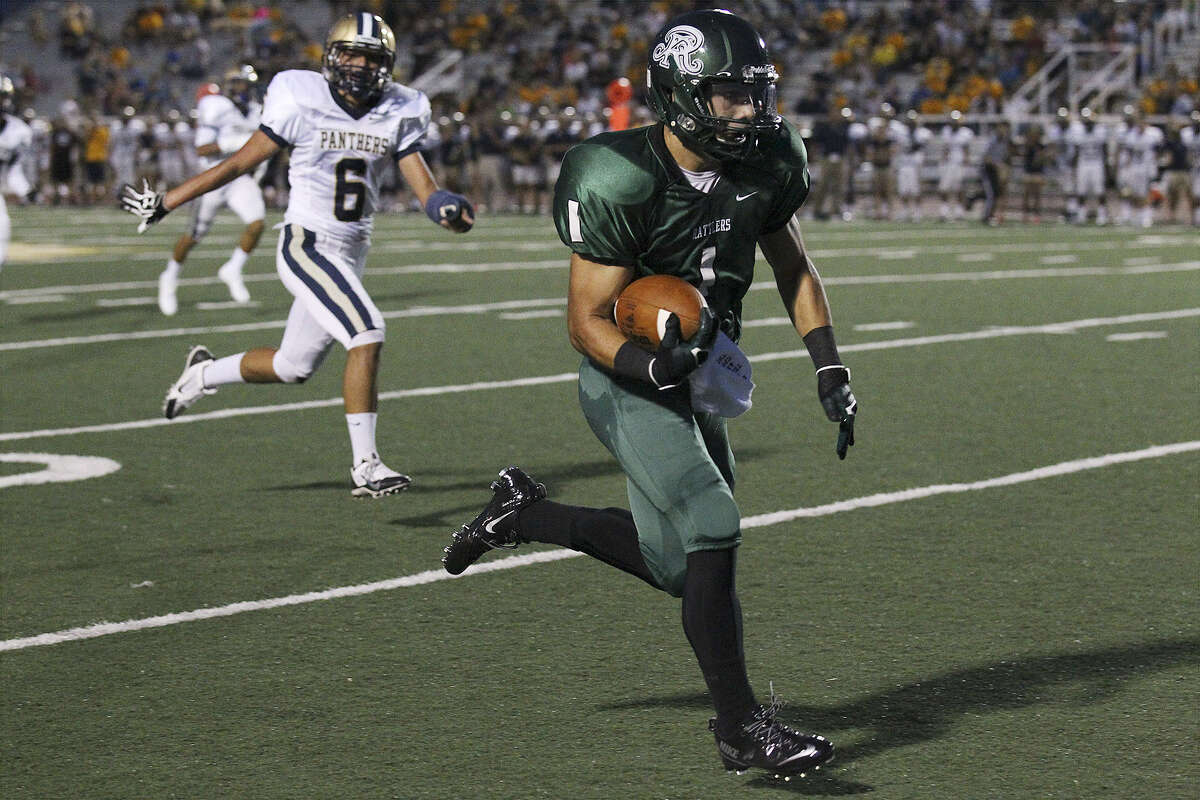 Reagan's Jacob Ramos (right) pulls away from O'Connor's Reynaldo Zuniga to score at Comalander Stadium. The Rattlers rallied from a 14-point deficit to win their eighth straight against the Panthers.