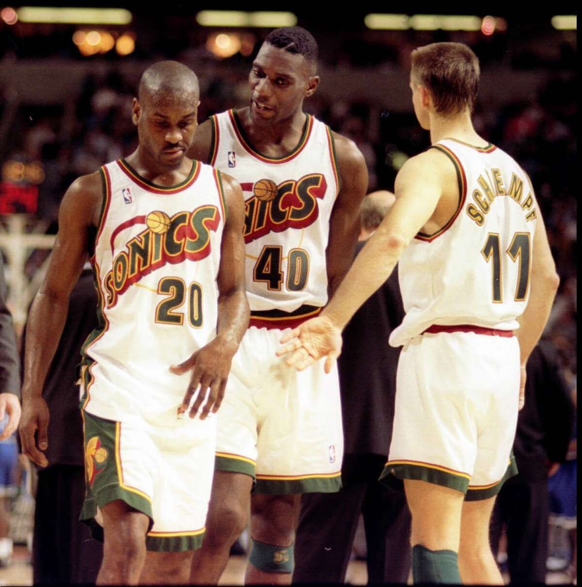 After being kicked out of a 1996 game for head-butting the Orlando's Joe Wolf, Gary Payton is encouraged by Shawn Kemp (40) and Detlef Schrempf (11) as he leaves the court. The three were core members of head coach George Karl's Sonics teams.