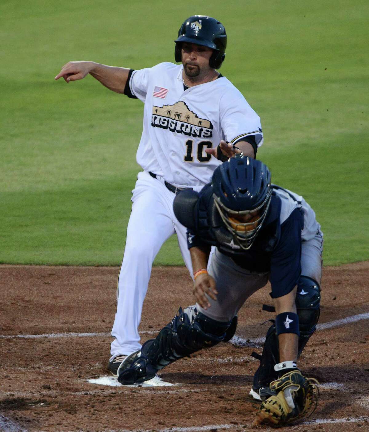 Jake Blackwood of the San Antonio Missions is forced out at home by Corpus Christi catcher Carlos Corporan in the second inning of Texas League playoffs action at Wolff Stadium on Saturday, Sept. 7, 2013.