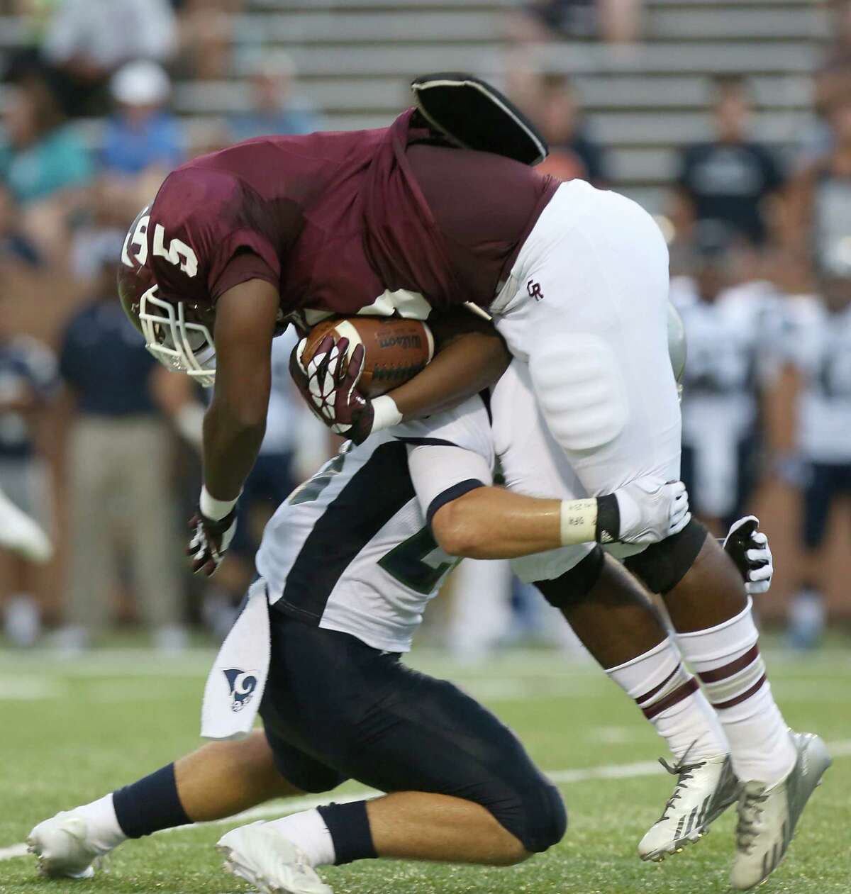 9/7/13: Cinco Ranch Cougar Denzell Bates #5 is tackled by Cy Ridge Ram Justin McBride #27 at Rhodes Stadium in Katy, Texas.