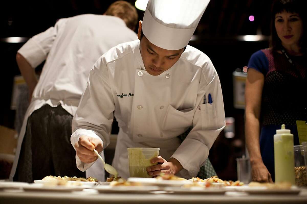Seong Jun Ahn, a student at CIA, makes fish tacos for Jole during the Appellation Trail Tasting, a Flavor! Napa Valley event, at The Culinary Institute of America at Greystone in St. Helena, Calif., Friday, November 16, 2012.