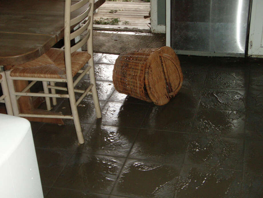 The Kitchen photo shows the mud that was left behind, and the watermark on the dishwasher. My home was on pier and beam and about 3-1/2 feet above ground, but 14 inches of water flooded the house. The door in the Back Deck photo is the same door you see in the kitchen photo. Photo: Karen Heck