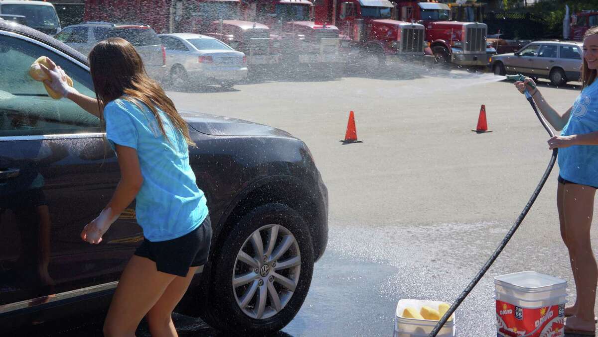 Tackling grime: Staples cheerleaders make splash at car wash