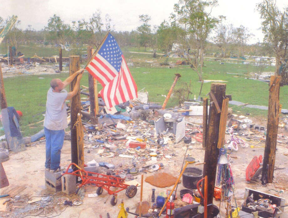 This picture is of my son Michael Casanover putting an American flag on what was left of his house after Ike hit. He lived on Oak Island, Texas in Chambers County the water got to at lease 15 feet in this area his house was 8 feet in the air. Photo: Cynthia Sanders-Froehlich