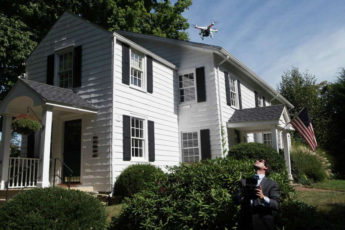 Mark Pires, a realtor with Coldwell Banker, flies his custom built quad copter, which simultaneously shoots stills and video, at a Fairfield home on Monday, Sept. 9, 2013. Pires is the first Real Estate agent to offer this state of the art aerial service personally.