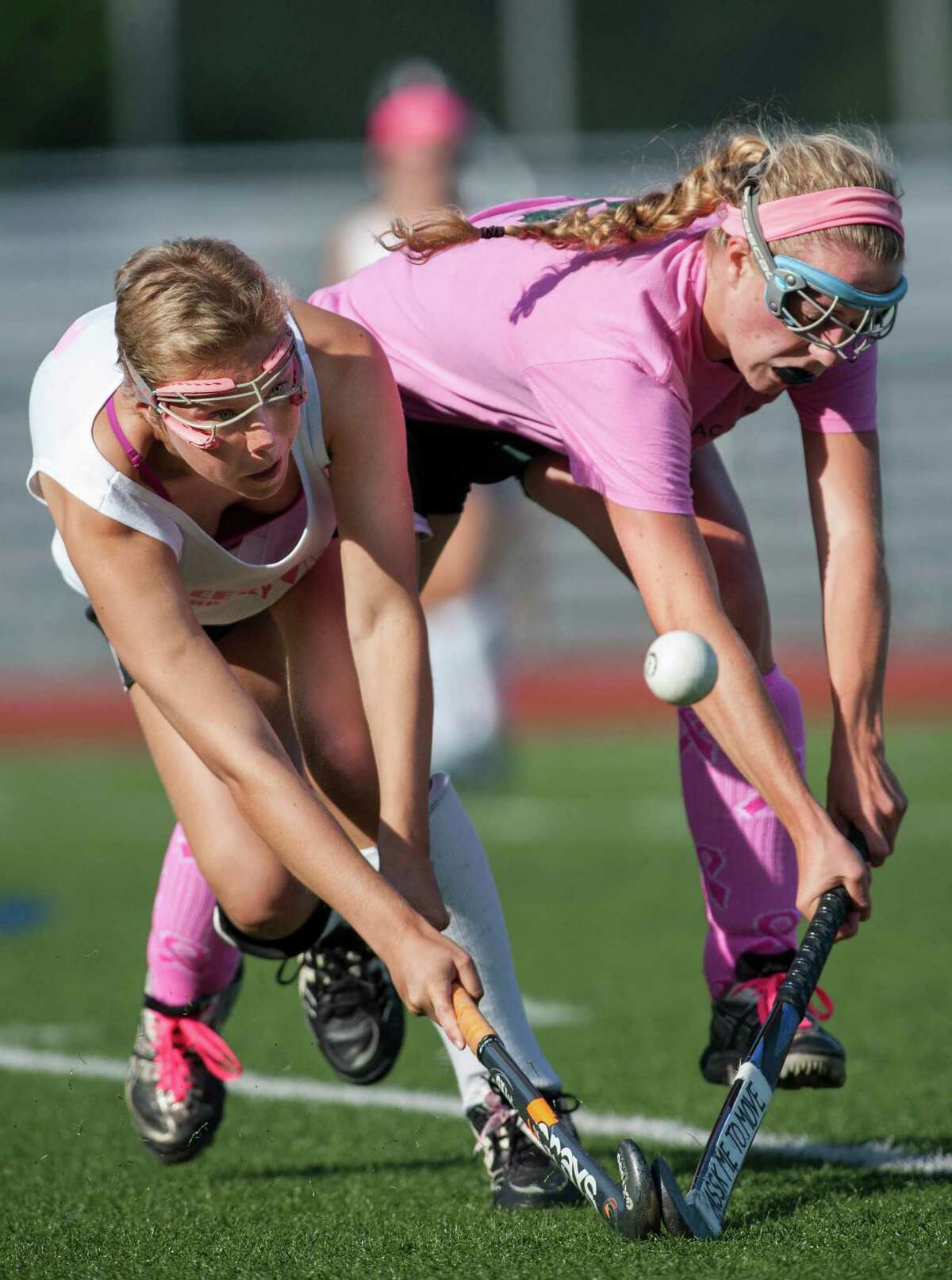 Greenwich high school's Nicole Graham and Greenwich Academy's Katrina Kraus fight for the ball during a girls field hockey game played at Greenwich high school, Greenwich, CT on Monday September 9th, 2013.