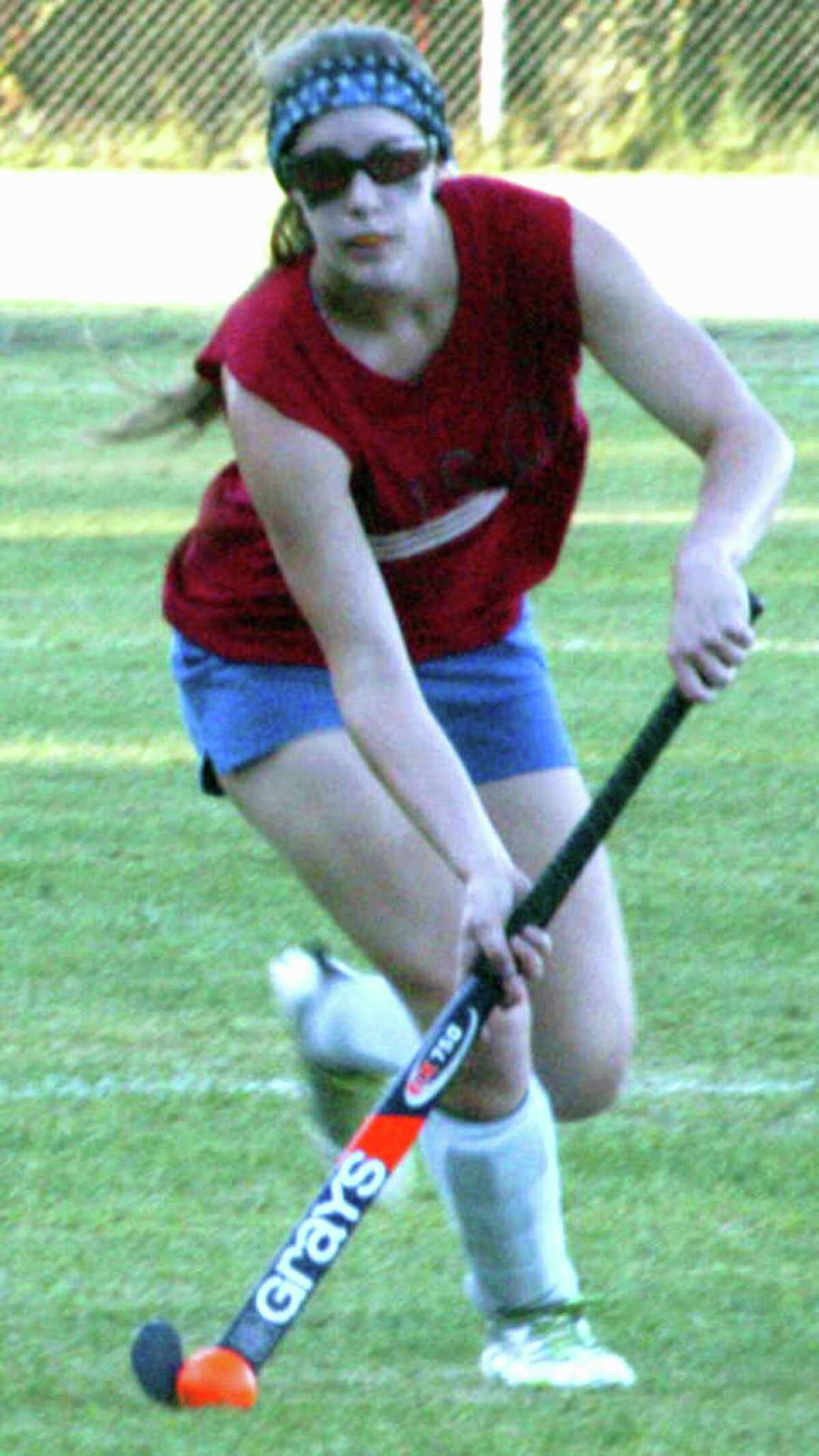 The Green Wave's Natalie Capriglione studies the field before making a pass during pre-season for New Milford High School field hockey, September 2013