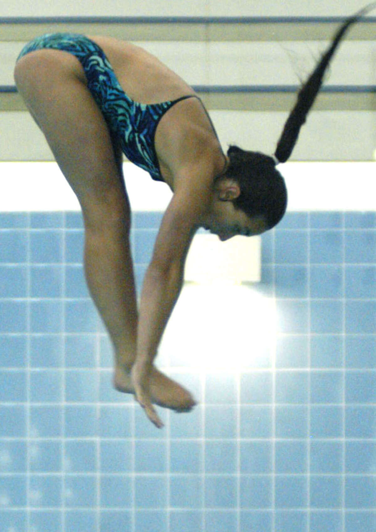 Yet another excellent dive is anything but a hair-raising experience for Green Wave senior Alison Profeta as she preps for the New Milford High School girls' swimming and diving season. September 2013 at Canterbury School