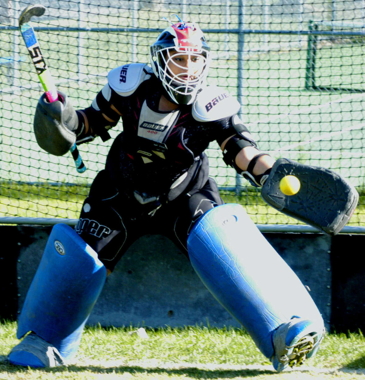 Sophomore goaltending prospect Sadie Fleming makes a save with the glove hand during pre-season practice for Shepaug Valley High School field hockey. September 2013