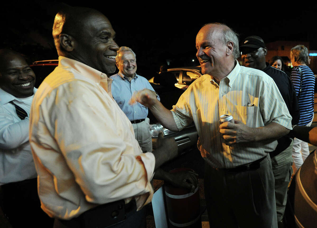Andre Baker, left, and Dave Hennessey congratulate each other on their victory, along with fellow challenger Howard Gardner, in the Democratic primary for Board of Education at the Red Rooster Deli on North Street in Bridgeport, Conn. on Tuesday, September 10, 2013.