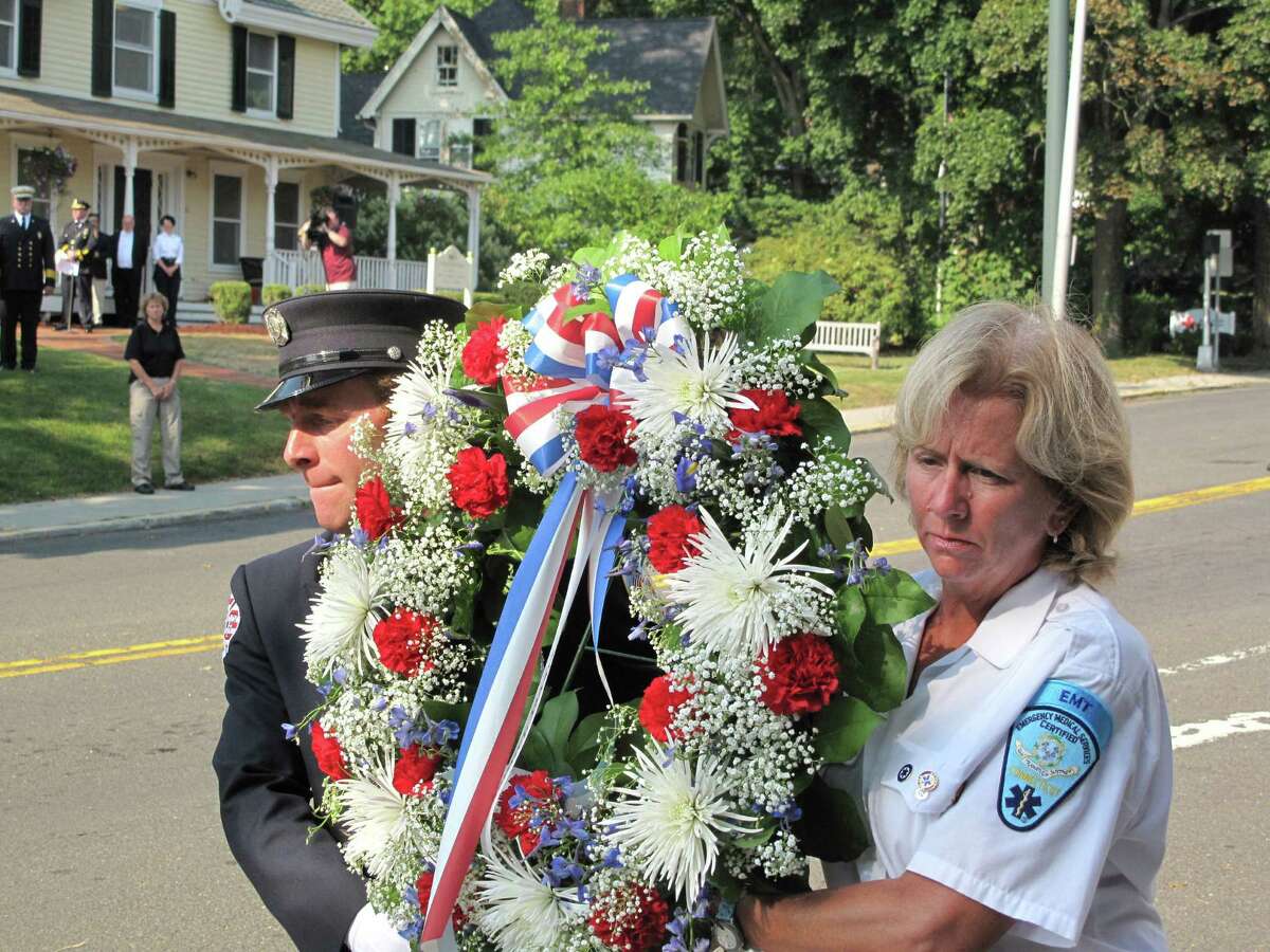 Residents, officials, members of the police and fire departments, and volunteers for the town's emergency services gathered on the lawn of Vine Cottage in New Canaan, Conn. on Wednesday, Sept. 11, 2013 for a memorial service of the attacks on 9/11/01.