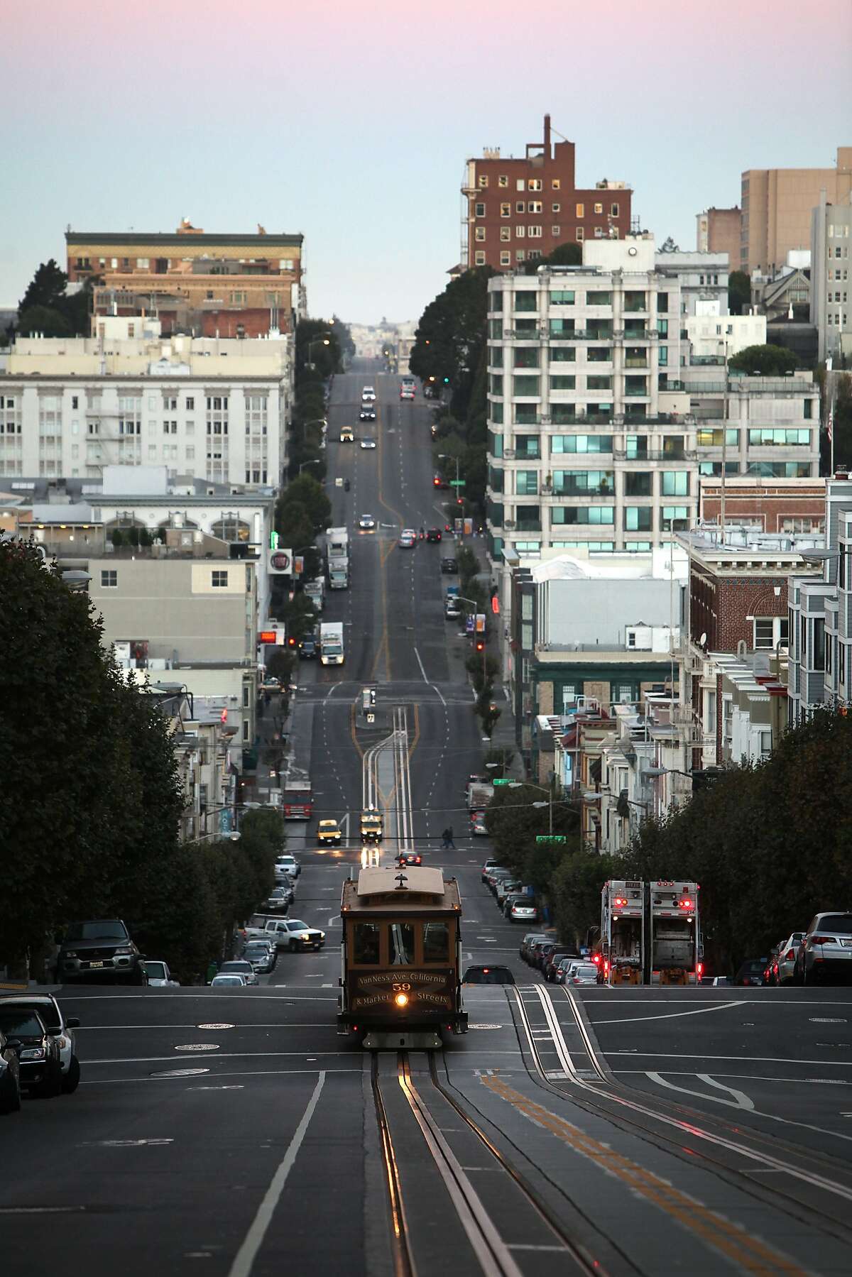 A cable car ascends Nob Hill on California Street at Leavenworth Street before sunrise on September 6, 2013 in the Nob Hill area of San Francisco, Calif.
