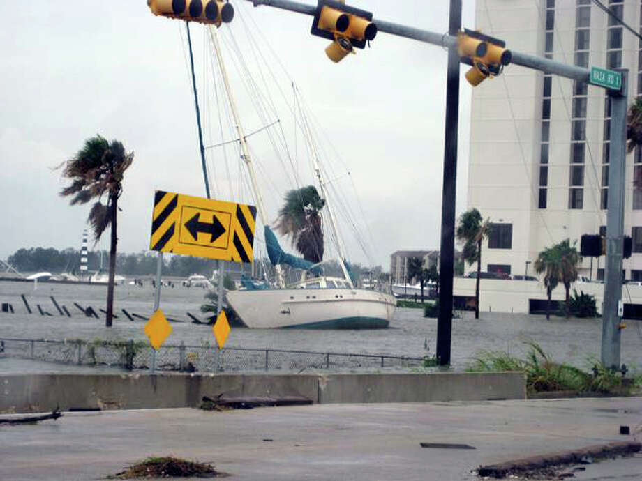 Next to the Hilton on Nasa Road One, the marina there is gone. The boat in the foreground is about 20 yards off the highway. Note all the sunken craft behind. Photo: Charles Hulvey
