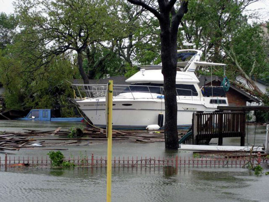 A 38-foot power boat floats in the street and parking lot behind the Hilton in Bal Harbour. Note the flooded pickup truck next to it in the third photo. Photo: Charles Hulvey