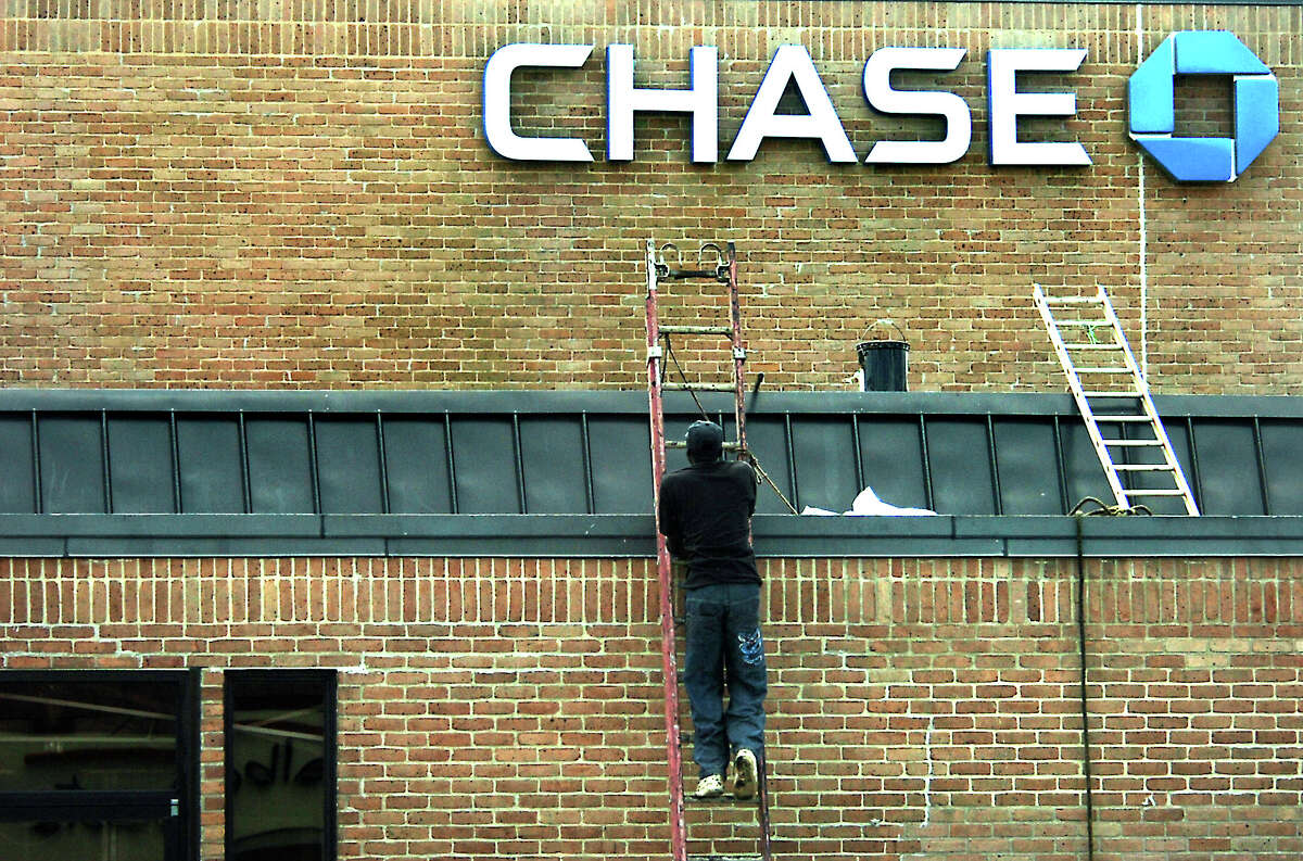 A worker climbes a ladder to repair roof damage at Chase Bank in Beaumont, TX, Friday, September 14, 2007. Hurricane Humberto roared into the area Thursday with high winds and heavy showers. (Beaumont Enterprise, Tammy McKinley)