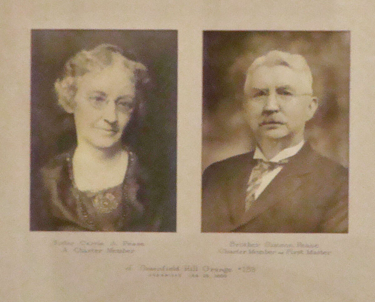 At the Greenfield Hill Grange, this photo is displayed of Carrie Pease and her brother Simeon Pease. Both are identified as charter members and Simeon Pease is listed as the local grange's first master when the organization was founded in 1893.