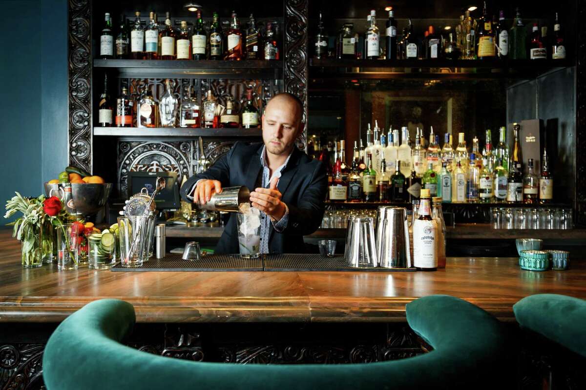 Bartender Curtis Childress makes a drink at Rosemont Social Club, Friday, Sept. 6, 2013, in Houston. ( Michael Paulsen / Houston Chronicle )