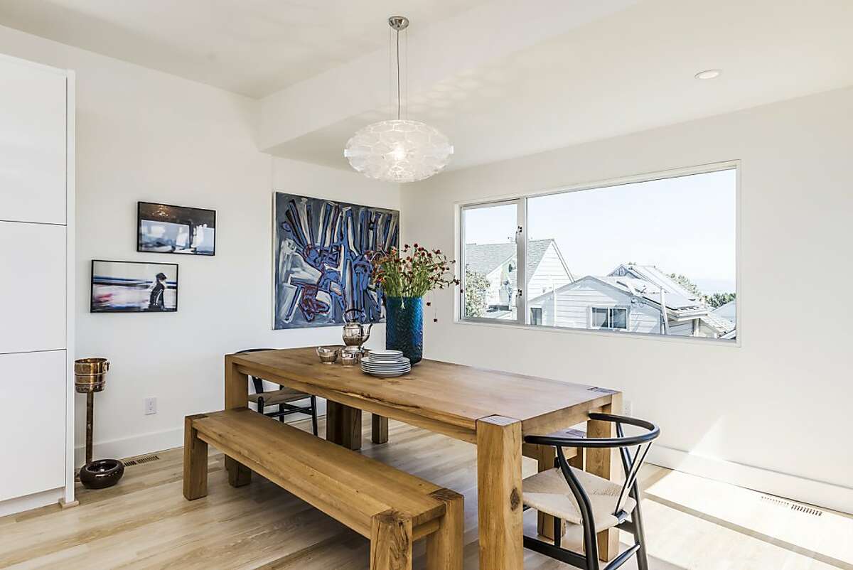 The dining room offers radiant heat floors and a large window looking out at the neighborhood.