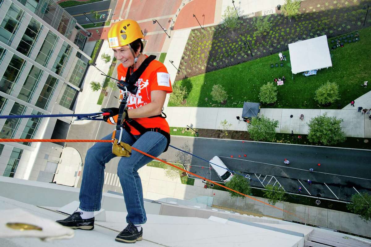 Elena Moffly rappels down 101 Park Place at Harbor Point in Stamford, Conn., during Over the Edge, a fundraiser for Special Olympics Connecticut.