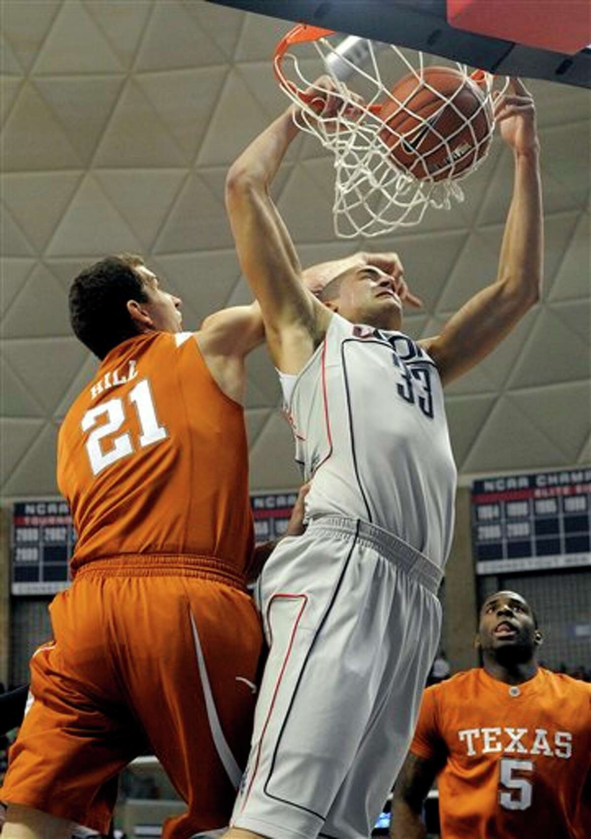 Texas's Matt Hill, left, fouls Connecticut's Gavin Edwards during the first half of their NCAA men's college basketball game in Storrs, Conn., on Saturday, Jan. 23, 2010. (AP Photo/Fred Beckham)