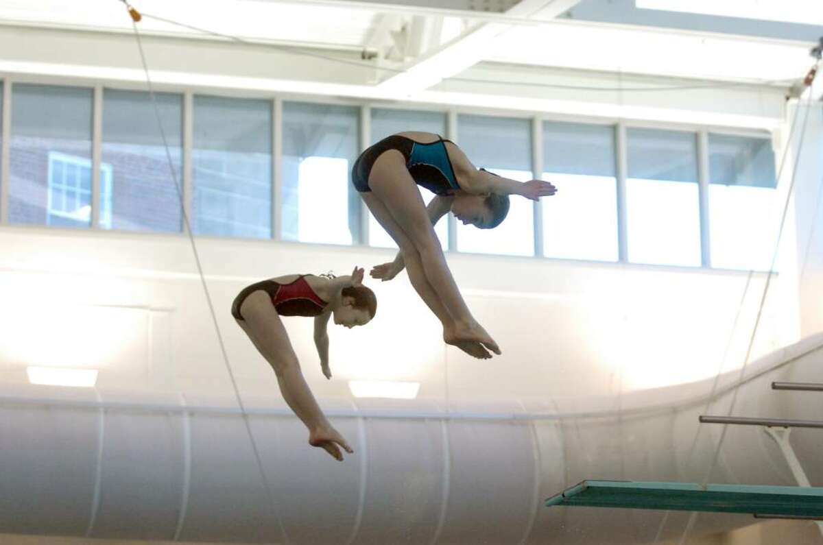 Rachel Burston, left, and Caleigh Kuppersmith dive during the CHAMPS Dive-a-thon on Saturday, January 23, 2010 in the Greenwich Family YMCA Natatorium. Kirsten Parkinson, 14, organized a Dive-a-thon so she and her Marlin Dive Club teammates could raise money for CHAMPS (Children Against Mines Program) International, an initiative of the Marshall Legacy Institute that helps children who are victims of landmines.