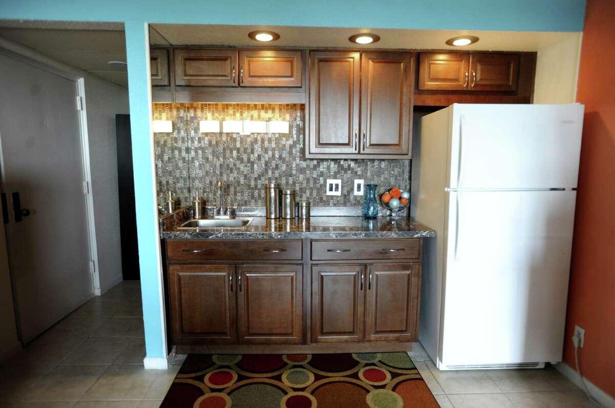 The kitchen in Avery's condo was renovated with new cabinets, countertop and sink. Doing away with a full-size stove allowed him to have a full-size fridge. Cooking is done with an electric hot plate, microwave and toaster oven.
