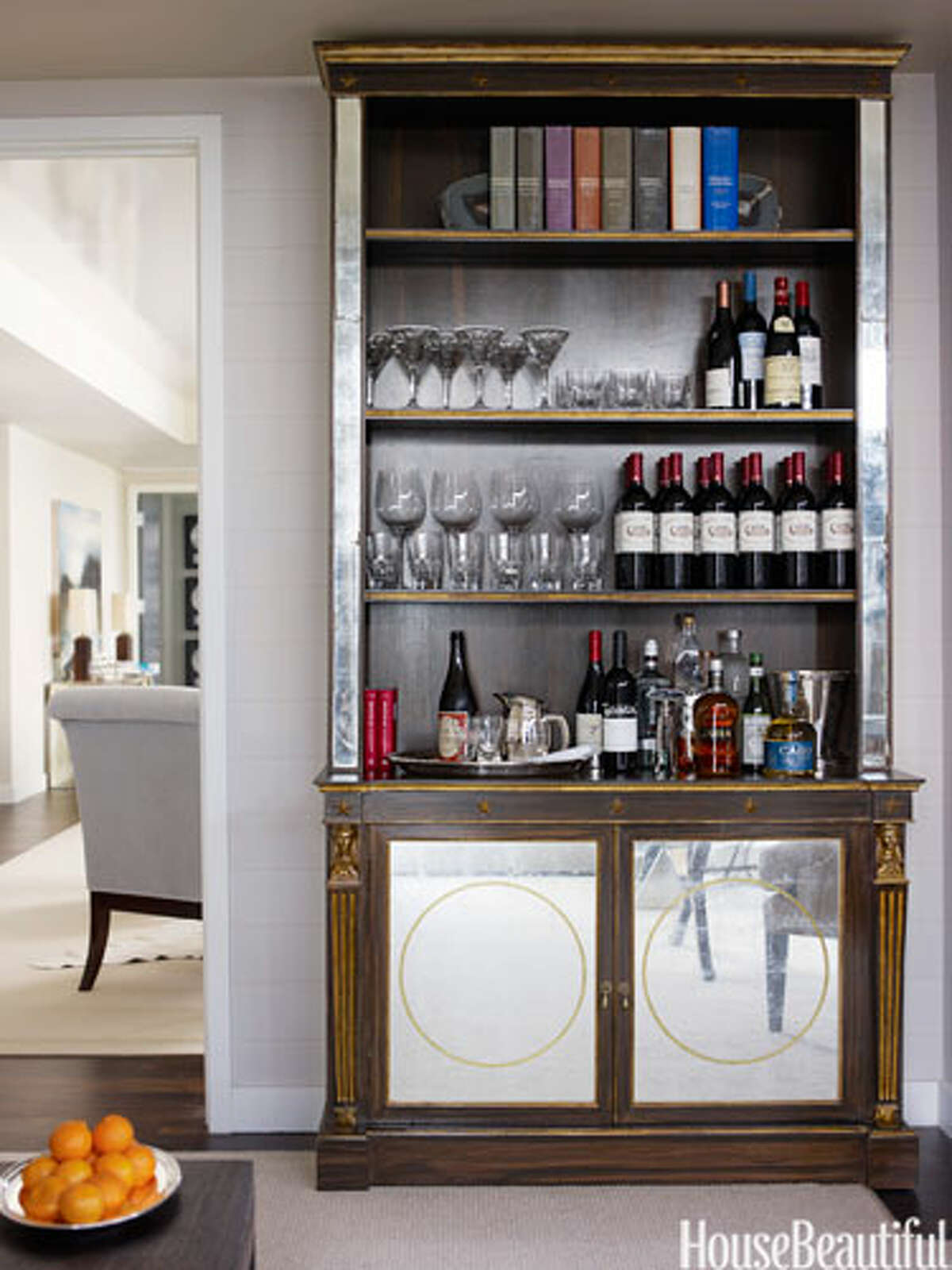 Bookcase Bar An antique bookcase doubles as a bar in this Manhattan apartment designed by Phoebe and Jim Howard. Glassware by William Yeoward Crystal.