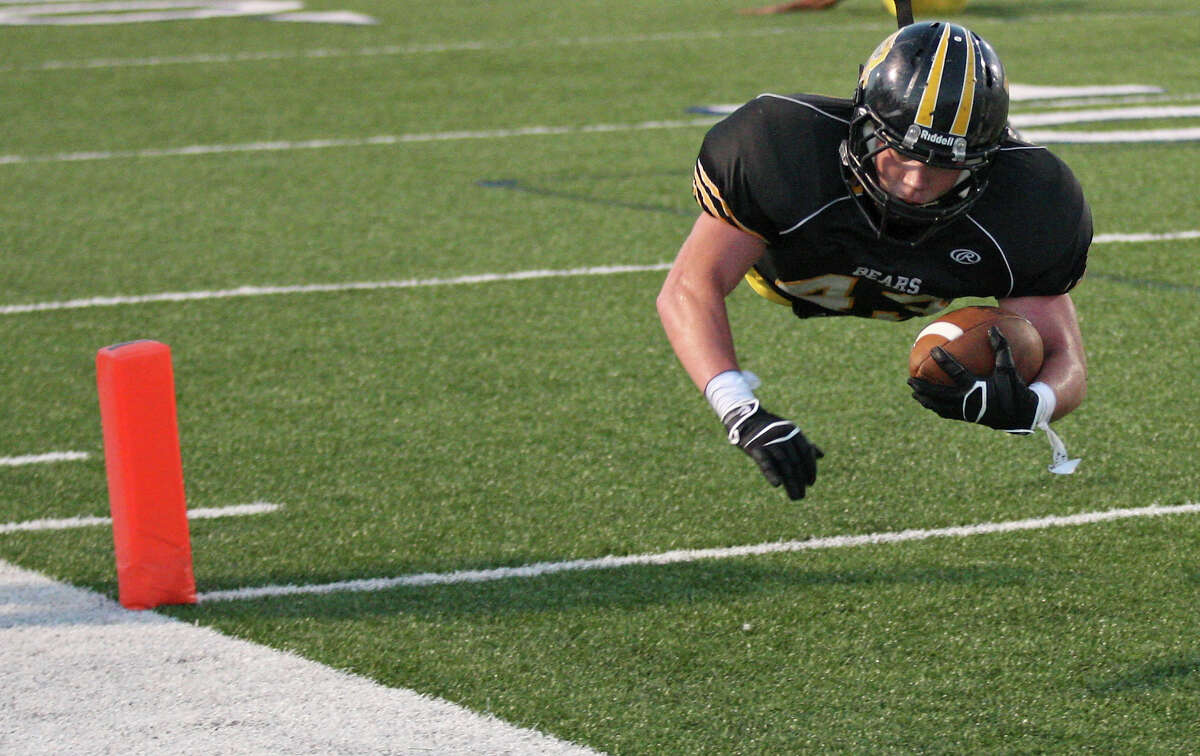 Brennan's Jeremy Kelleher dives into the end zone for a touchdown against East Central during first half action Thursday Sept. 12, 2013 at Farris Stadium.