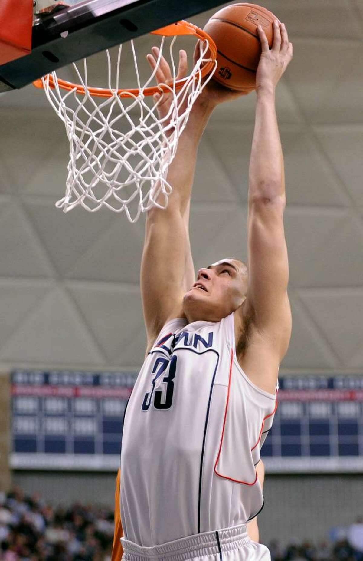 UConn's Gavin Edwards dunks the ball during the first half of Saturday's game against Texas at Gampel Pavilion.