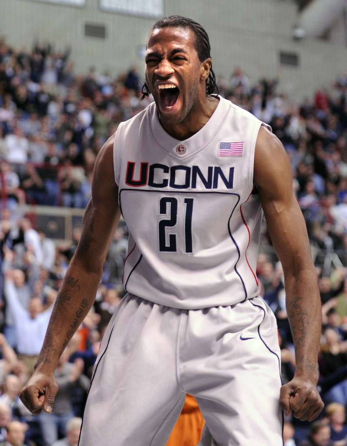 UConn's Stanley Robinson reacts after a dunk in the first half of Saturday's game against Texas at Gampel Pavilion.