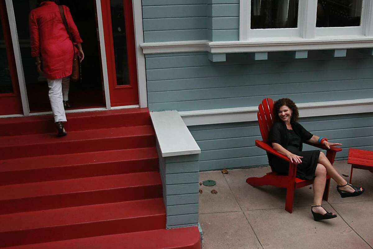 Broker Associate Corey Weinstein, right, of Red Oak Realty pictured in front of a two-story, three bedroom home as Realtor Catherine Stern walks inside, left, September 12, 2013 in Oakland. The house is on the market for $679,000.