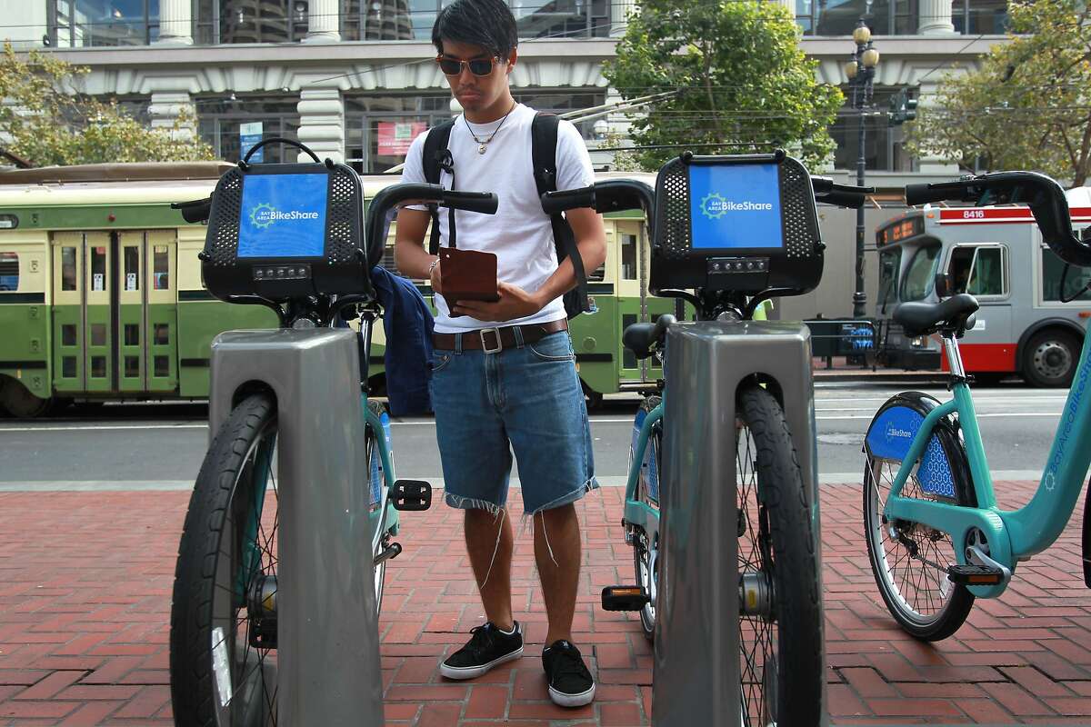 Yuta Takano struggles to figure out how to remove his bike after paying for it at a Bay Area Bike Share station September 11, 2013 in downtown San Francisco. Takano, who is visiting from Japan, tried for about twenty minutes before giving up in pursuit of alternate transportation. The new program offers stations sprinkled throughout the city in which pedestrians can rent and return bikes from at any hour.