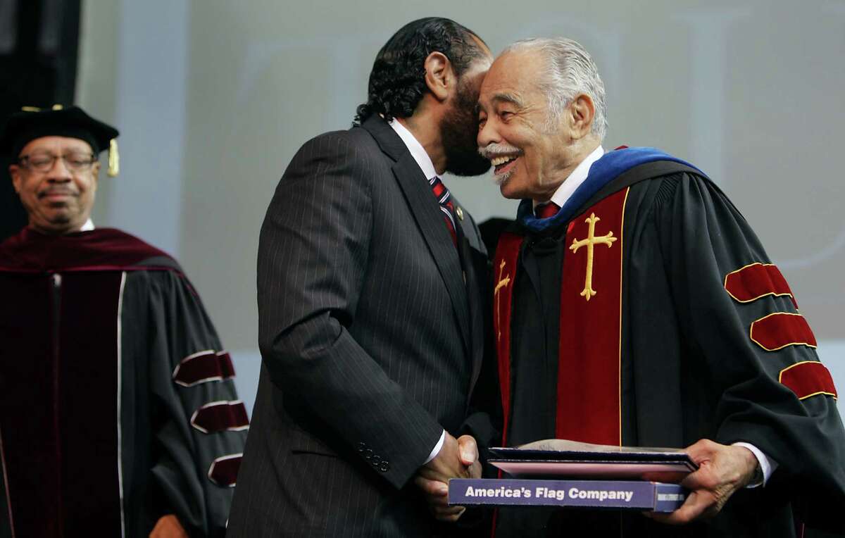 U.S. Rep. Al Green, left, presents a flag flown over the U.S. Capitol to Thomas F. Freeman on Friday to commemorate Freeman's 69 years of service to Texas Southern University. ﻿